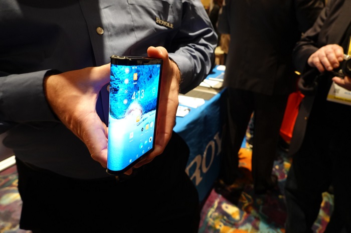 A Man bending the foldable smartphone